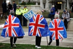 FILE - People celebrate Britain leaving the EU on Brexit Day at Parliament Square in London, Jan. 31, 2020.