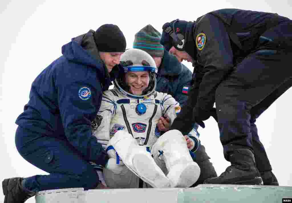 Astronot Rusia, Sergey Ryazanskiy dibantu untuk keluar dari kapsul Soyuz setelah mendarat di dekat kota Zhezkazgan, Kazakhstan.