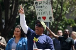 FILE - Demonstrators attend a rally to protest the police shooting of Stephon Clark, in Sacramento, Calif., March 31, 2018.