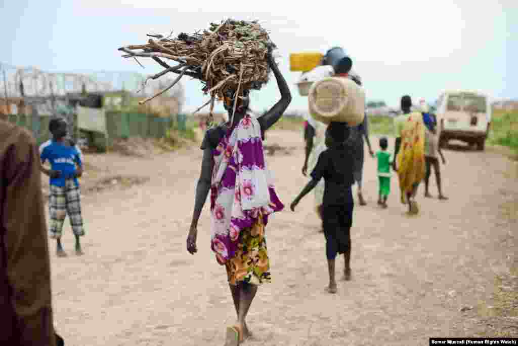 Women and children venture outside the UNMISS camp near Bentiu, in South Sudan, to collect firewood and charcoal. Unity state, of which Bentiu is the capital, has seen an uptick in fighting since the last round of peace talks collapsed in March, and leavi