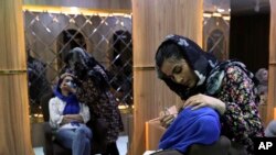 Sultana Karimi applies makeup on a customer at Ms. Sadat’s Beauty Salon in Kabul, Afghanistan, Sunday, April 25, 2021. Kabul's young working women say they fear their dreams may be short-lived if the Taliban return to Kabul. (AP)
