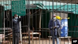 A man is turned away by a guard after he tried to get the Sinopharm coronavirus vaccine at a health facility in Harare, Zimbabwe, June, 8, 2021, as in the global race to vaccinate people against COVID-19, Africa is tragically at the back of the pack.