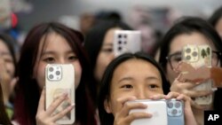 Fans record on their cell phones at KCON at the Los Angeles Convention Center on Friday, Aug. 18, 2023. 