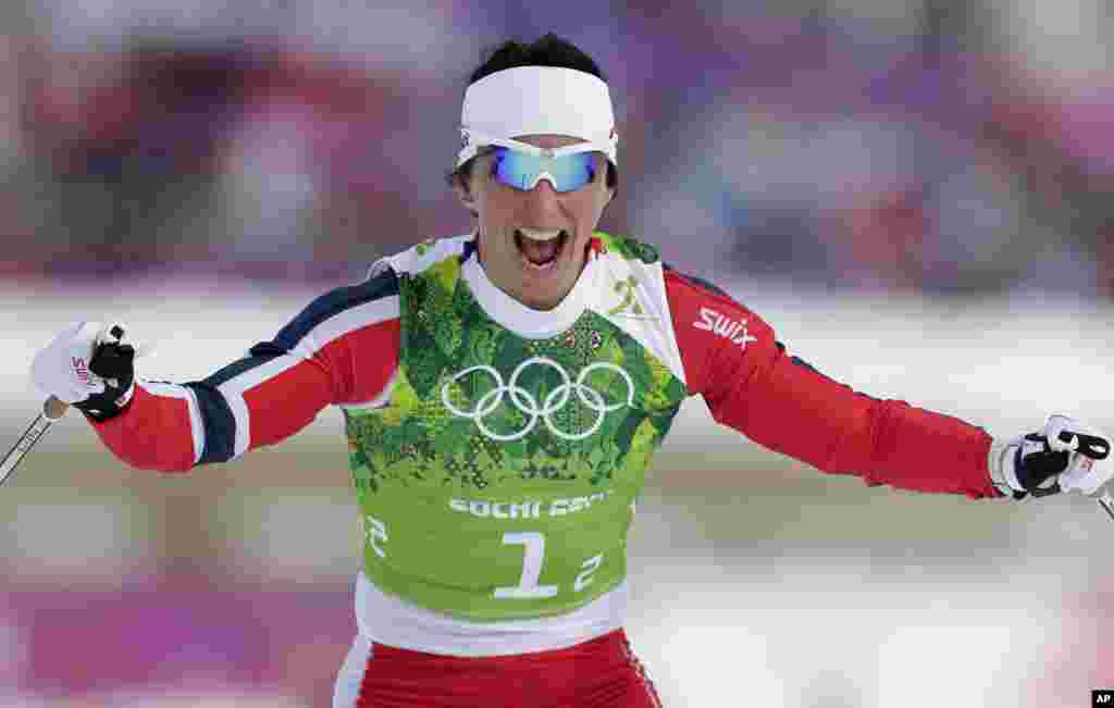 Norway&#39;s Marit Bjoergen celebrates winning her gold during the women&#39;s cross-country team sprint competitions. This win brings her career total to five gold medals, Krasnaya Polyana, Feb. 19, 2014.