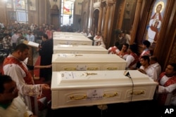 Coffins of the slain Coptic Christians are seen during their funeral service at the Church of Great Martyr Prince Tadros, in Minya, Egypt, Nov. 3, 2018.