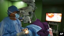 Dr. Sanduk Ruit tengah melakukan operasi katarak di Tilganga Eye Center, Kathmandu, Nepal, 26 Maret 2021. (AP Photo/Niranjan Shrestha)