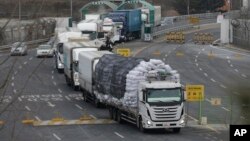 South Korean vehicles returning from North Korea's joint Kaesong Industrial Complex pass the customs, immigration and quarantine office near the border village of Panmunjom, in Paju, South Korea, Feb. 11, 2016.