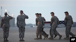 An Army carry team carries the transfer case containing the remains of Army Sgt. John Castro, of Andrews, Texas, at Dover Air Force Base, DE Saturday, April 23, 2011