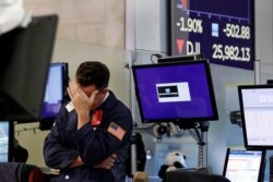Trader James Coffey works on the floor of the New York Stock Exchange, Aug. 5, 2019.