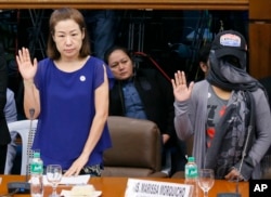 Choi Kyung-jin, left, widow of South Korean businessman Jee Ick-joo, and their former housekeeper, appear before Philippine Senate Committee.