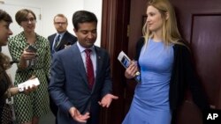 FILE - Florida Republican Rep. Carlos Curbelo is followed by reporters as he arrives for the Republican Caucus meeting on Capitol Hill in Washington, May 2, 2017. With voter dissatisfaction with President Donald Trump on the rise, Curbelo says he was the first among House members to mention impeachment.