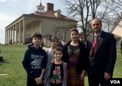 Bibi Mariam Jamalzai (C) poses for a photo with her family on the day that she became an American citizen at Mount Vernon Feb. 22, 2017. With Jamalzai are her husband, Azmat (R) and their three children, from left, Ahmad, Sara and Mustafa.