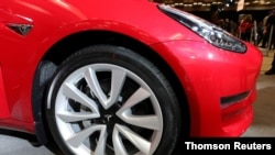FILE - A Tesla Model 3 electric vehicle is displayed at the Canadian International Auto Show in Toronto, Canada, Feb. 18, 2020.