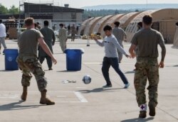 U.S. Air Force airmen play soccer with Afghan evacuees at Ramstein Air Base, Germany, Aug. 21, 2021. (Airman Edgar Grimaldo/U.S. Air Force photo)
