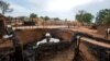 A man is seen inside a burnt house during clashes between nomads and residents in Deleij village, central Darfur, Sudan, June 11, 2019. 
