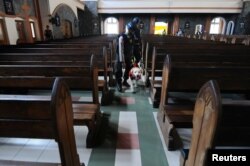 Indonesian K9 unit policemen holds his dog as he examines a church before Christmas mass prayer in Salatiga, Indonesia, Dec. 24, 2017. Antara Foto/Aloysius Jarot Nugroho/via Reuters