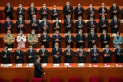 Delegates applaud as Chinese President Xi Jinping arrives for the closing session of China's National People's Congress (NPC) in Beijing, May 28, 2020.