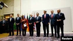 EU foreign policy chief Catherine Ashton, third from left, delivers statement during ceremony marking deal between Iran, six world powers, United Nations, Geneva, Nov. 23, 2013.