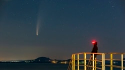 The Comet Neowise or C/2020 F3 is seen before sunrise over Balatonmariafurdo, Hungary, Tuesday, July 14, 2020. It passed closest to the Sun on July 3 and its closest approach to Earth will occur on July 23. (Gyorgy Varga/MTI via AP)