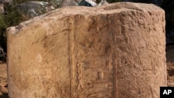 This undated photo released by the Egyptian Ministry of Antiquities, shows part of a stone slab that was discovered at a dig in eastern Cairo's Matariya neighborhood, Egypt. The Antiquities Ministry said on Tuesday, Nov. 6, 2018, that archeologists working at the dig have found several fragments of stone slabs with inscriptions dating back up to 4,000 years. Some of the fragments date back to the 12th and the 20th Dynasties and the Third Intermediate Period while others are more recent. 