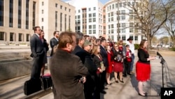 Kristen Slough, wife of Paul Slough, is joined by family members and supporters of four former Blackwater security guards as she speaks following sentencing for a 2007 shooting of civilians in Iraq, at a news conference in Washington, April 13, 2015.