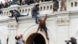 Supporters of U.S. President Donald Trump climb on walls at the U.S. Capitol during a protest against the certification of the 2020 U.S. presidential election results by the U.S. Congress, in Washington, U.S., January 6, 2021. REUTERS/Stephanie Keith