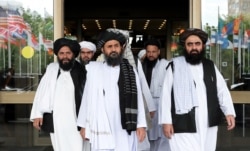 FILE - Members of a Taliban delegation leave after peace talks with Afghan senior politicians in Moscow, May 30, 2019.
