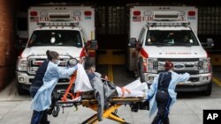 Patients are brought into Wyckoff Heights Medical Center by staff wearing personal protective gear due to COVID-19 concerns, April 7, 2020, in the Brooklyn borough of New York. 