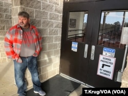 FILE - Many Arkansan schools have begun arming faculty in hopes of preventing a future school shooting. Coach Dale Cresswell stands outside a Heber Springs, Ark., school, Dec. 11, 2018 (T.Krug/VOA News)