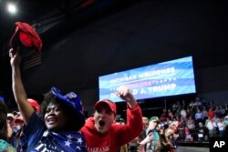 People cheer as President Donald Trump speaks at a campaign rally in Grand Rapids, Mich., March 28, 2019.