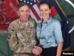 General David Petraeus, former CIA chief and Commander of the International Security Assistance Force/U.S. Forces in Afghanistan, shakes hands with author Paula Broadwell in this handout photo from ISAF, originally posted July 13, 2011.