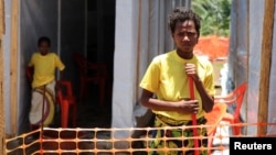 Rose Komono poses for a picture at a health clinic after overcoming the Ebola virus, in Gueckedou, Guinea, April 3, 2014.