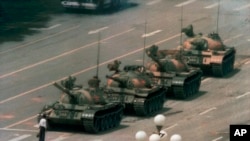 FILE - In this June 5, 1989, file photo, a Chinese man stands alone to block a line of tanks heading east on Beijing's Changan Boulevard in Tiananmen Square.