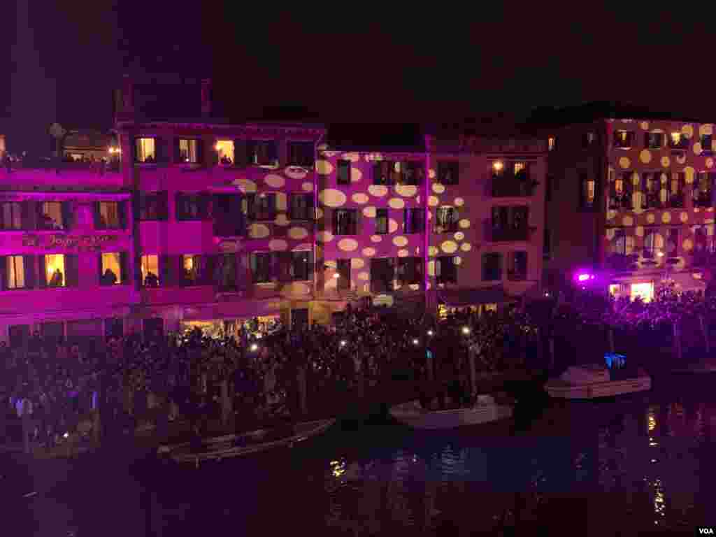 A light show at the Venice Carnival is played on the buildings along the canals, in Venice, Italy, Feb. 8, 2020.