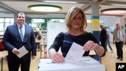 FILE - Croatia's president Kolinda Grabar Kitarovic casts her vote at a polling station in Zagreb, Croatia, May 26, 2019. 