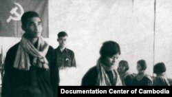 This photograph shows the wedding of Nun Huy aka Huy Sre (left) and Prok Khoeun aka Prak Samuth (right). Huy was born in 1951 and served as head of the Khmer Rouge re-education center at Prey Sar, also known as Office S-24. Prey Sar was part of the central internal security complex in Democratic Kampuchea, which also included Toul Sleng Prison (S-21) and the Killing Fields at Choeung Ek. One prison document, dated 23 July 1977, reports the killing of 18 prisoners at S-24 and bears a note saying "also killed 160 children today for a total of 178 enemies killed." Duch, who oversaw both S-24 and S-21, testified this week that Huy was killed after the escape of his radio operator from Prey Sar. Huy's wife, Prok Khoeun (b. 1953), was an official at S-24 until June 1977, when she became the deputy of an interrogation team known as the "hot group" at Toul Sleng. Source: Documentation Center of Cambodia, Document No. D1175 and K08273. by Dr. John D. Ciorciari.