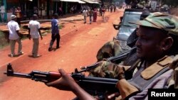 Armed fighters from the Seleka rebel alliance patrol the streets in pickup trucks to stop looting in Bangui, March 26, 2013. 