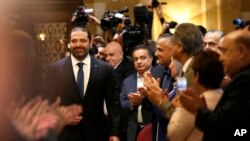Journalists and supporters of Lebanese Prime Minister-designate Saad Hariri, left, clap as he arrives for a press conference, in Beirut, Lebanon, Nov. 13, 2018.