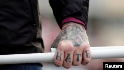 FILE - A tattoo is seen on a hand of a supporter of Italy's far-right Forza Nuova party during a demonstration in Rome, Italy, November 4, 2017.