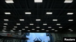 FILE - Fighter jets are seen on China's aircraft carrier Liaoning during a military drill of the Chinese People's Liberation Army (PLA) Navy in the East China Sea, April 20, 2018.
