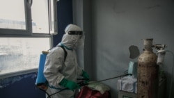 MADAGASCAR – A health worker disinfects a room at the Andohatapenaka University Hospital. Source: AFP