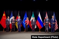 US Secretary of State John Kerry poses for a group photo with fellow EU, P5+1 foreign ministers and Iranian Foreign Minister Zarif after reaching Iran nuclear deal, in Vienna, Austria, July 14, 2015.
