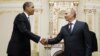 US President Barack Obama, left, shakes hands with Vladimir Putin at Novo Ogaryovo in Moscow, July 7, 2009 (file photo).