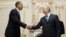 US President Barack Obama, left, shakes hands with Vladimir Putin at Novo Ogaryovo in Moscow, July 7, 2009 (file photo).
