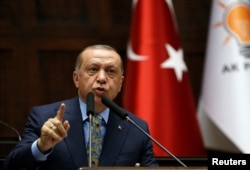 Turkish President Tayyip Erdogan addresses members of parliament from his ruling AK Party (AKP) during a meeting at the Turkish parliament in Ankara, Turkey, Oct. 23, 2018.
