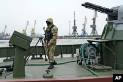 A Ukrainian serviceman stands on board a coast guard ship in the Sea of Azov port of Mariupol, eastern Ukraine, Dec. 3, 2018.