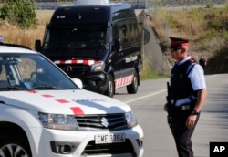 Armed police officers stand guard near Subirats, Spain, Aug. 21, 2017.