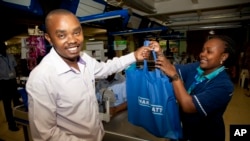 A customer carries his shopping in a cloth carrier bag in Nairobi, Kenya, Aug. 28, 2017. 