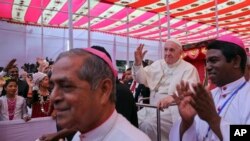 Pope Francis arrives on a cycle rickshaw at an event to meet representatives of different religions in Dhaka, Bangladesh, Friday, Dec. 1, 2017.