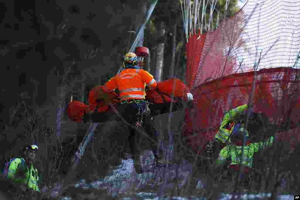 Medical staff transport France&#39;s Cyprien Sarrazin after crashing into the protections net during an alpine ski at the men&#39;s World Cup downhill training, in Bormio, Italy.